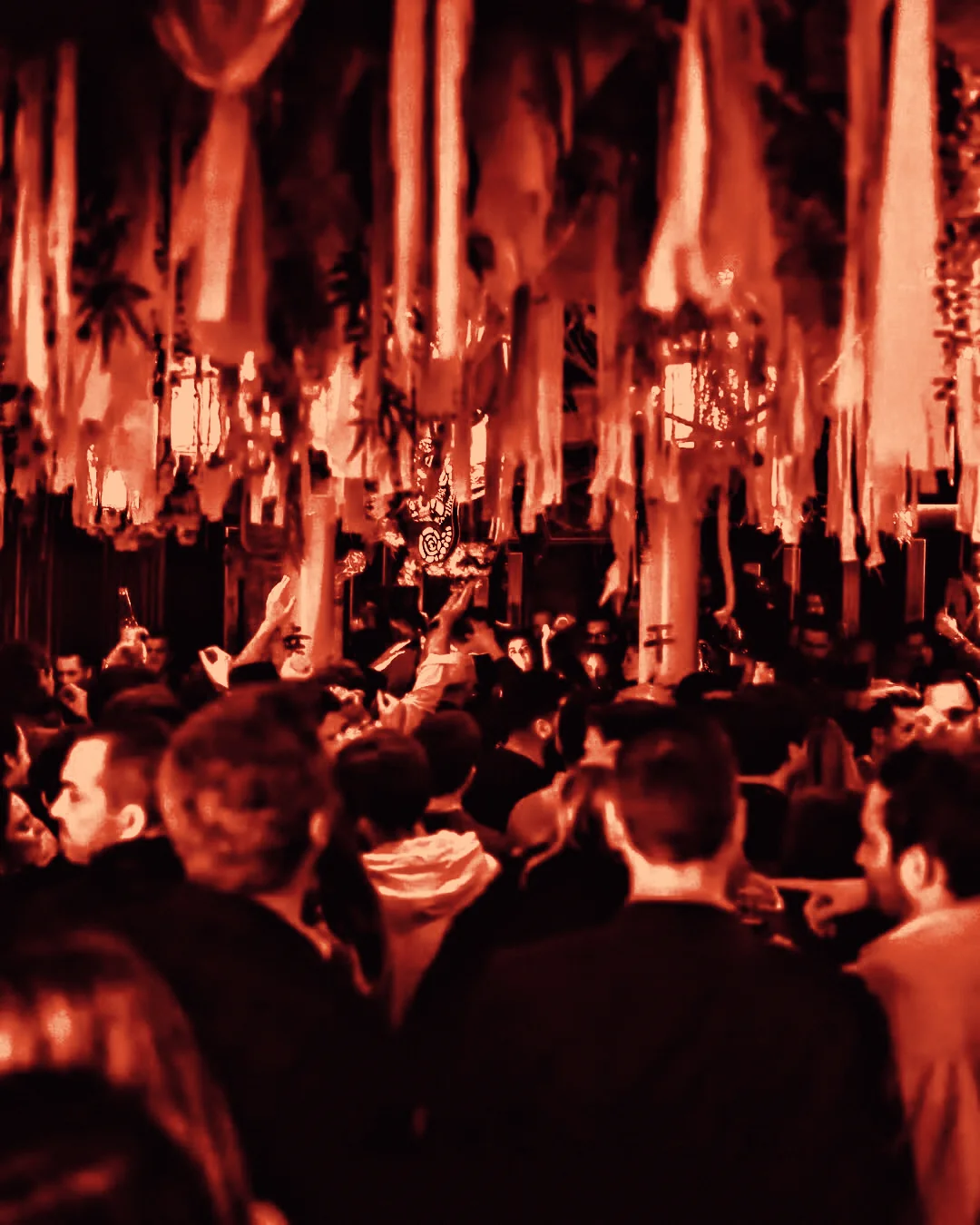 The crowd at Mirage under red light.